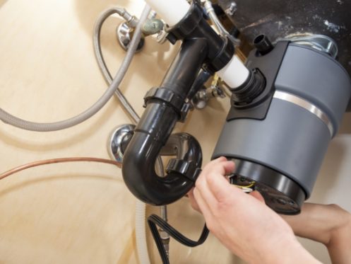 Plumber Installing Garbage Disposal in Residential Home near Wheeling, IL