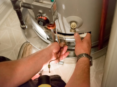 Plumber Repairing Water Heater in Residential Home in Wheeling, IL